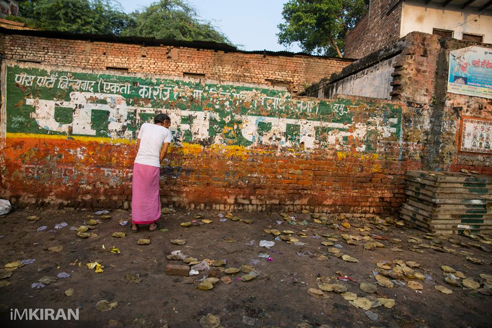 A local going about his ‘business’ doing no 1 on the wall in the streets of Arga, this was taken on my way to a dobi ghat on a rickshaw. - Agra, India