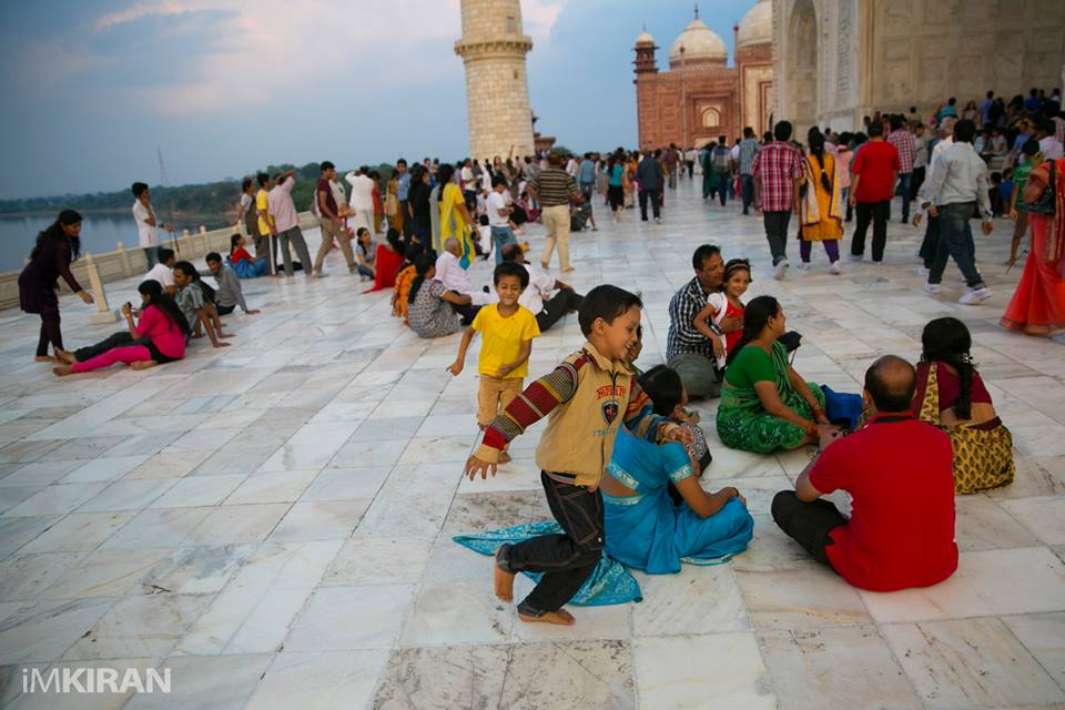 Kids playing catch, on the grounds inside the Taj Mahal.