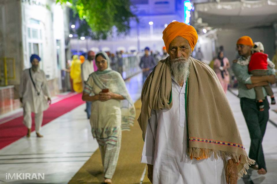 Devotees and Sikhs walking around the temple grounds during the early hours -Amritsar