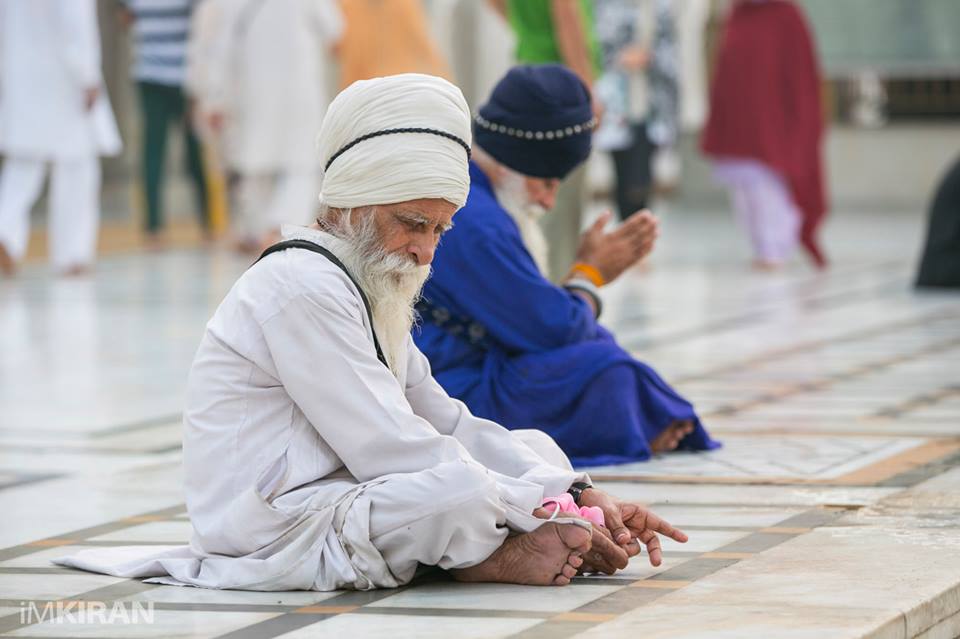 an old man sitting by the sides of the holy pool for days.
