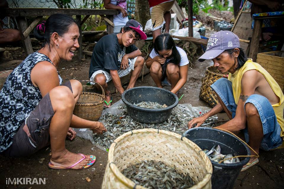 This family sits here every other day peeling shrimps and sorting out small fish outside their temporary shelters. This is from the fish farm in their village and since the typhoon the production has been low. But they still offered to cook me some shrimp and fish for dinner the next day. I couldn't make it as it rained heavily all day and most places were flooded.