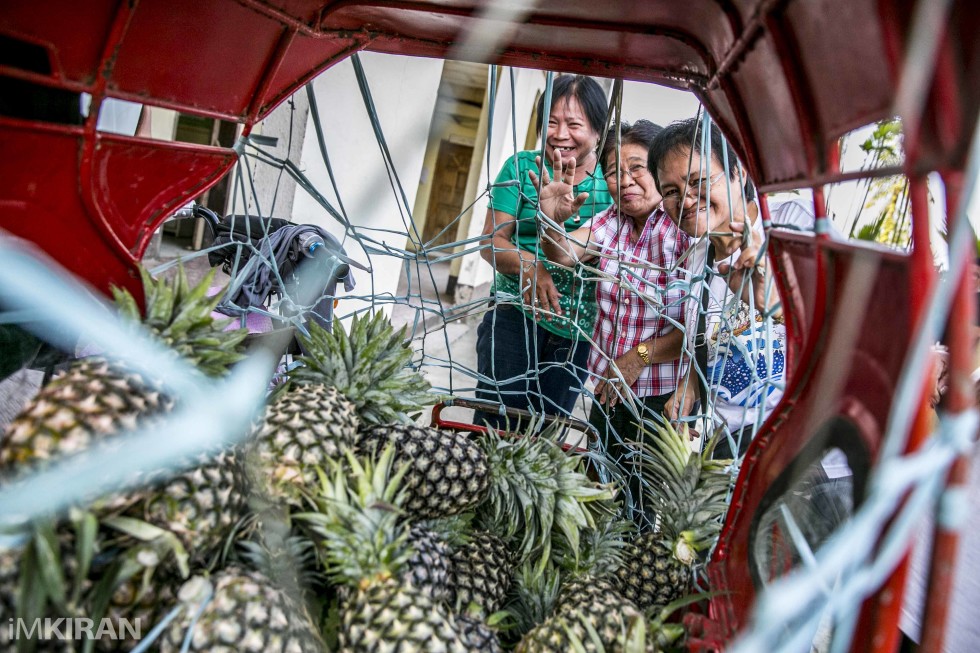 Locals in Pontevedra buying pineapples. They were being sold via a tricycle. Looks like its the season. Later a local offered me one, it was really juicy and sweet