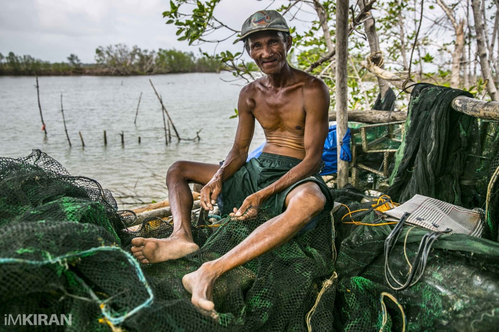Local fisherman from Blas, Butacal going on with getting the net ready for todays fishing. This is their main source of income.