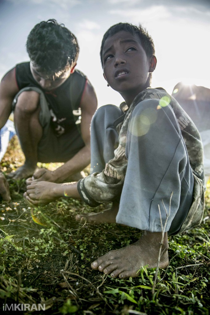The Indigenous Ati Tribe on Mount Tag-aw, Panay Island, Philippines. Ati boy here picking the corn after harvest. The Ati are a Negrito ethnic group in Panay, which is located in the Visayas.
