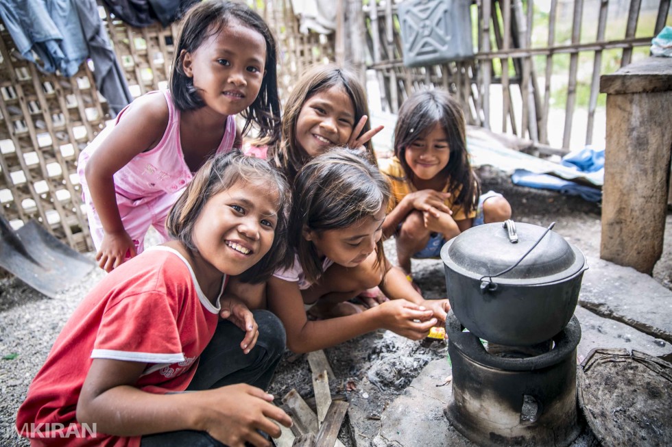 A local girl cooking some rice while the rest take a moment for the picture. The usual thing I always hear from the children here... "Sir, picture please".