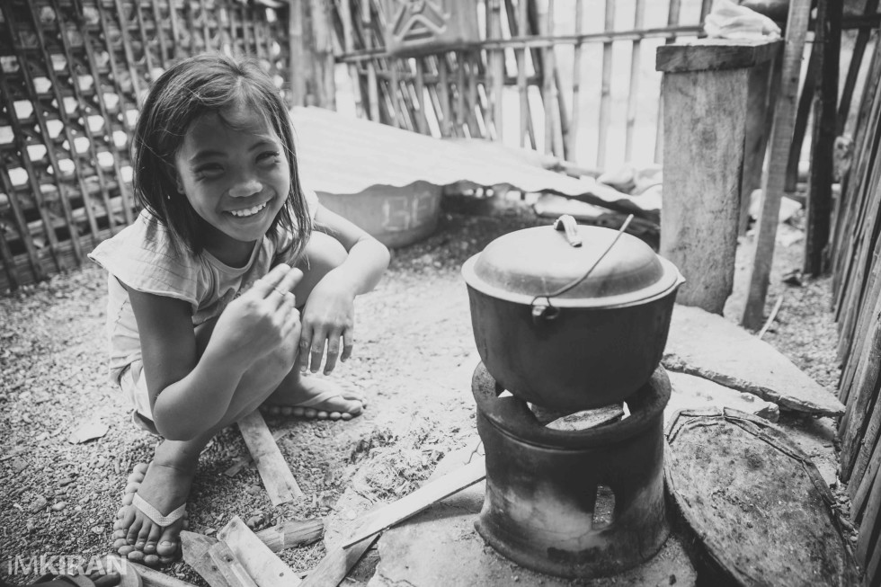 She was cooking some rice out here when I dropped in. - Baliguian Island, Panay - Philippines