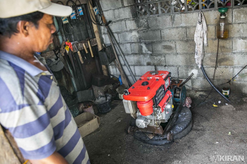 The island caretaker showing me the generator that they used currently, they have 2 hours of light daily and have to purchase the kerosene gas to run it.