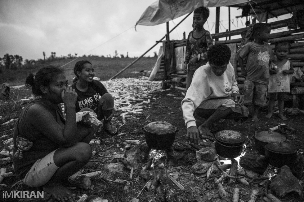 Sitting outside and making dinner at nightfall under the moon light, as thier homes still have no electric power - Ati tibe, Mount Tag-ao